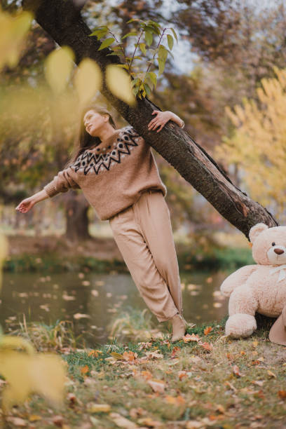 istock Girl with teddy bear in a beautiful natural park. 1187356049