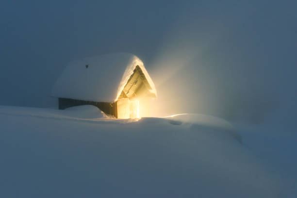 Fantastic winter landscape with wooden house in snowy mountains. Christmas holiday concept