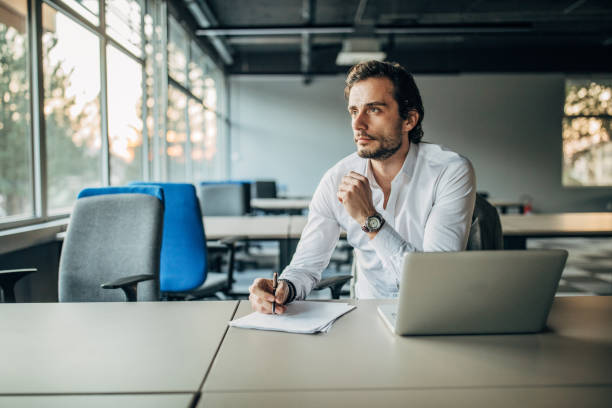 istock Handsome businessman working in office 1187357368