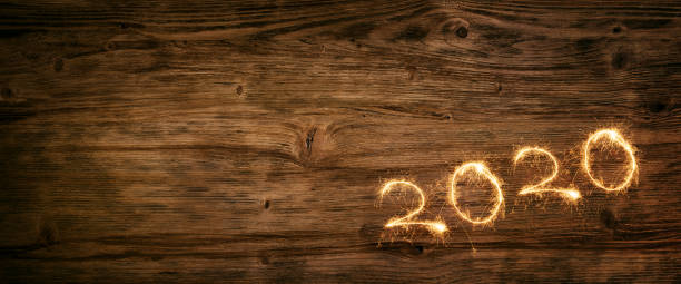 istock New year 2020 firework on wooden background 1187357393
