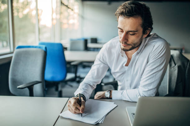 istock Young businessman working alone in office 1187357448