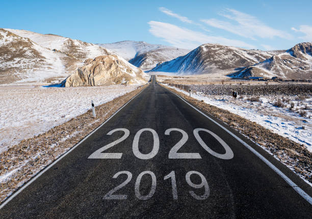 istock 2020 and 2019 on the empty road in winter. New Year concepts 1187358263