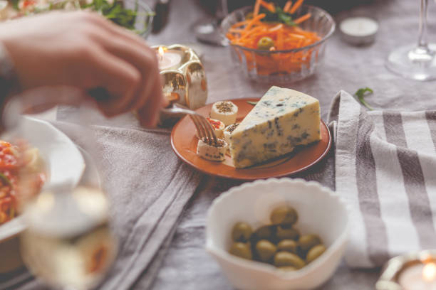 Delicious appetizers. Mini sandwiches with cheese, vegetables and meat. With a green olive on top. Food catering