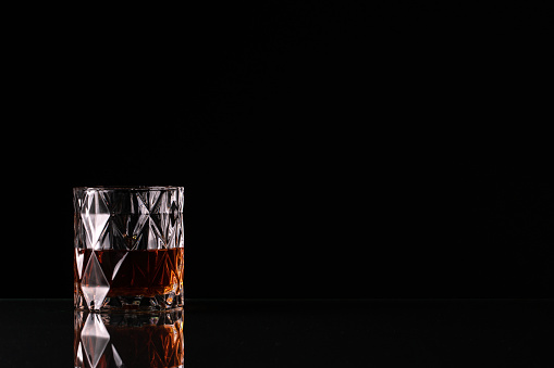 Bottle of transparent glass, with gin, tequila, rum, or vodka, isolated on pure white background.