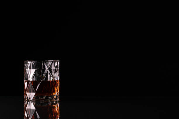 Glass with whiskey on black background Glass with whiskey on black background brandy photos stock pictures, royalty-free photos & images