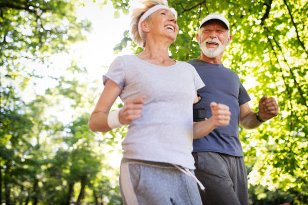 istock Senior couple jogging and running outdoors in nature 1187359940