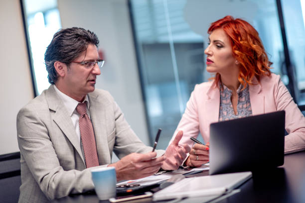 istock Two business colleagues working together on new project 1187360864