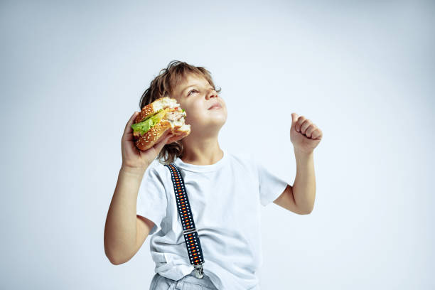 istock Pretty young boy in casual clothes on white studio background 1187361038