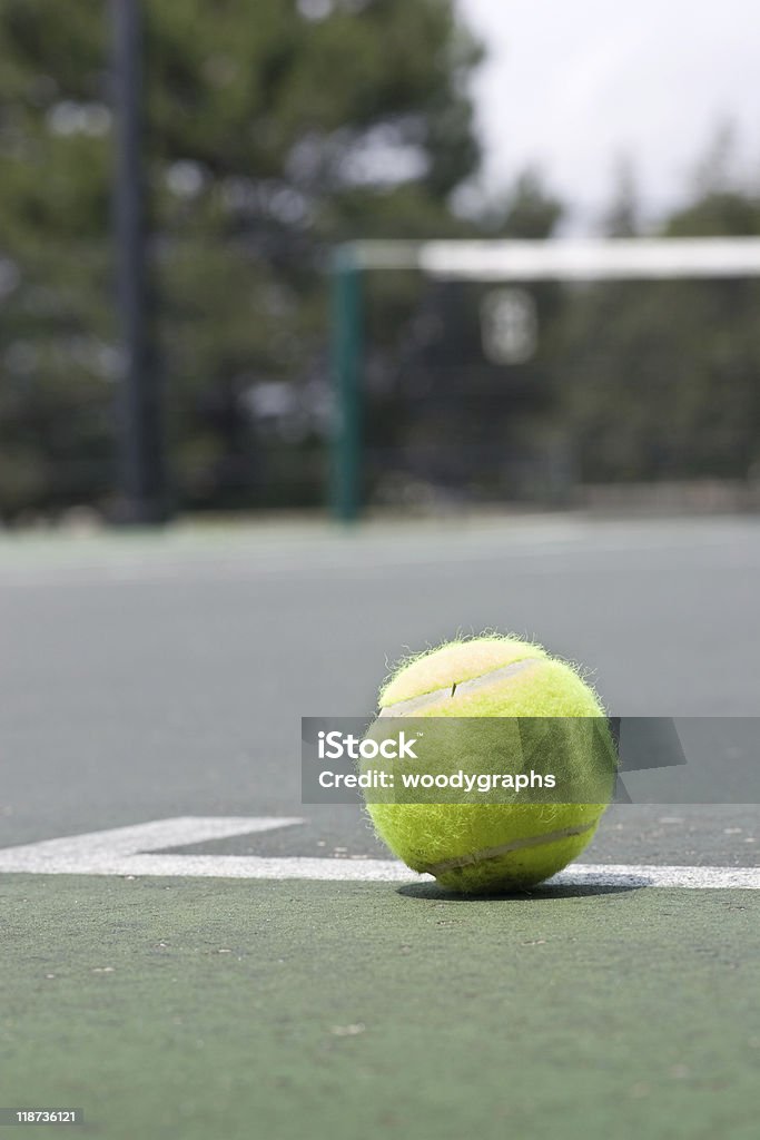 Closeup of tennis ball on base line  Asphalt Stock Photo