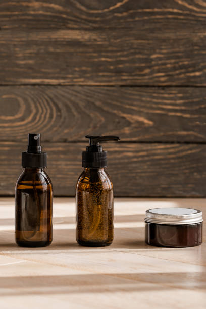istock Cosmetic dark amber bottles on wooden  table 1187362273