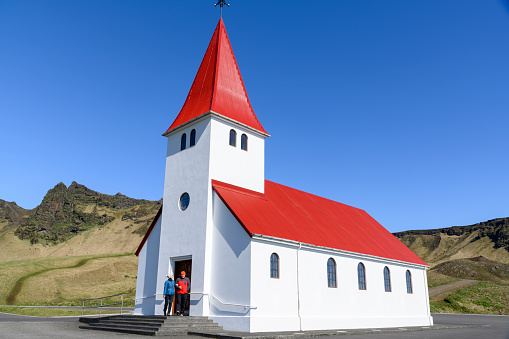 A couple in front of the church in Vik.