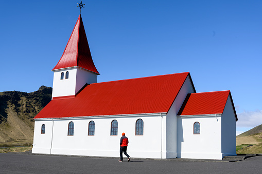 A lone tourist in front of the church in Vik.
