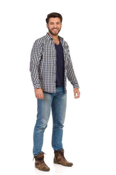 istock Relaxed Smiling Handsme Man Standing In Jeans And Unbuttoned Lumberjack Shirt. 1187363941