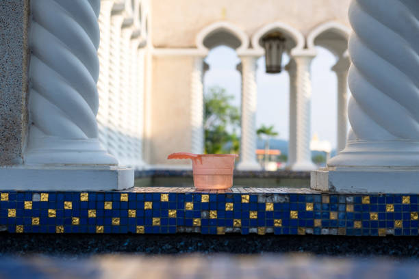 A container used for ablutions before Muslim prayer sits on a ledge at the Sultan Omar Ali Saifuddin Mosque in Bandar Seri Begawan, Brunei.