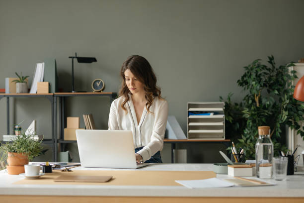 istock Pretty Businesswoman Working on her Laptop 1187365894