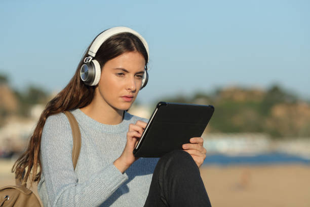 istock Concentrated girl e-learning with a tablet and headphones 1187366476