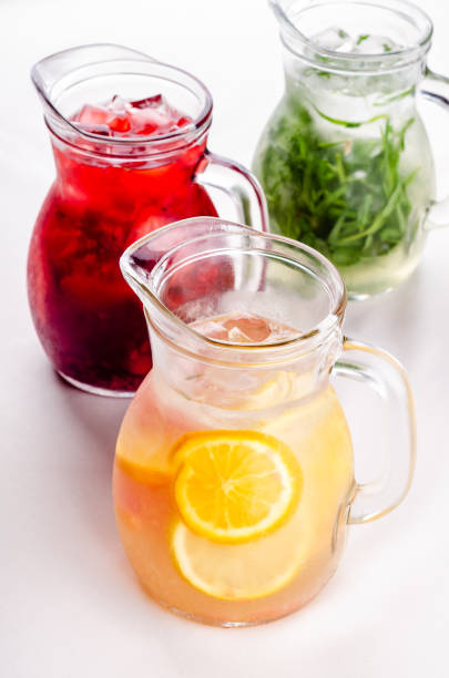 istock Cold and refreshing citrus cocktail with grapefruit and orange, strawberry, apple, lemon and herbs. Water for detox or dieting in glass jug on white background, copy space. Homemade drink. 1187369480