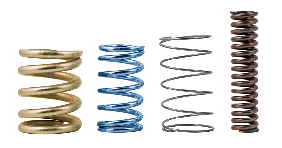 Springy metallic machine parts. Set of various elastic shock absorbers with spiral wire winding. Flexible colored dampers. Mechanical device to store energy