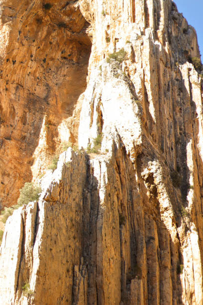 istock Brown red mountains shale steep cliffs near the trail, mountain trail along steep cliffs in Spain, Ardales the caminito caminito del rey. Tall red rocks mountain side in el Chorro 1187372382