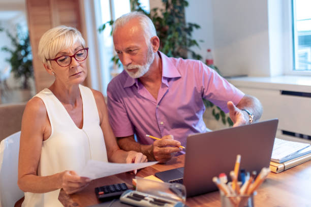 istock Senior couple at home using laptop 1187372632