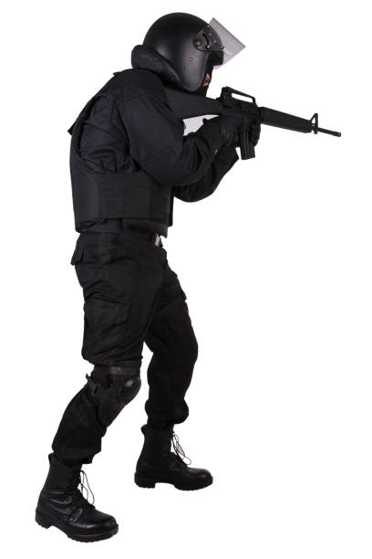 istock SWAT officer with assault rifle in black uniform 1187373842
