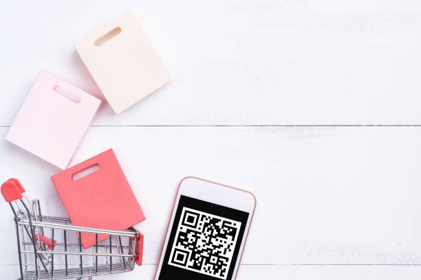 Abstract online shopping,mobile payment with QR code design concept element,colorful cart,paper bag on wooden table background,top view,flat lay