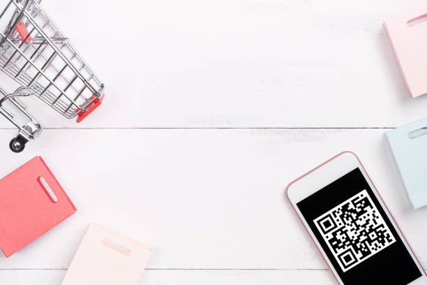 istock Abstract online shopping,mobile payment with QR code design concept element,colorful cart,paper bag on wooden table background,top view,flat lay 1187373891