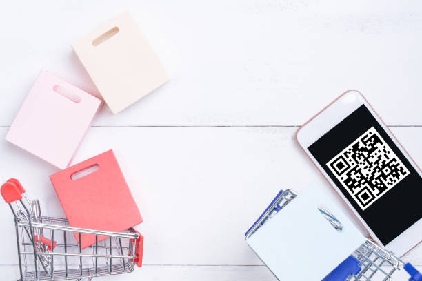 istock Abstract online shopping,mobile payment with QR code design concept element,colorful cart,paper bag on wooden table background,top view,flat lay 1187373897