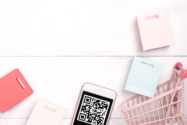istock Abstract online shopping,mobile payment with QR code design concept element,colorful cart,paper bag on wooden table background,top view,flat lay 1187373935