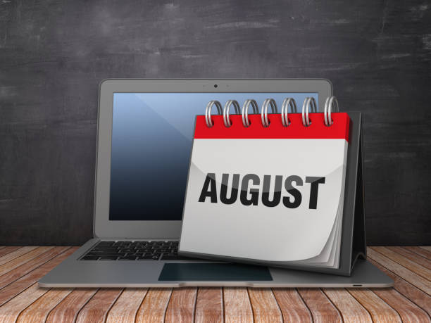 istock AUGUST Calendar with Computer Laptop on Chalkboard Background - 3D Rendering 1187375396