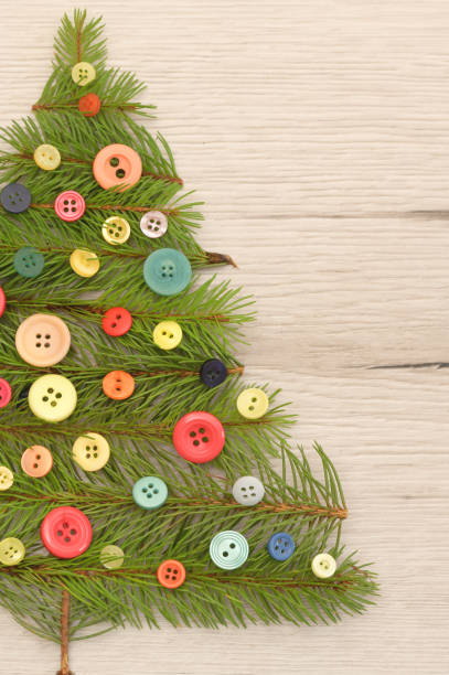 istock Christmas Tree Made With Pine Branches And Buttons on Wooden Table 1187379406