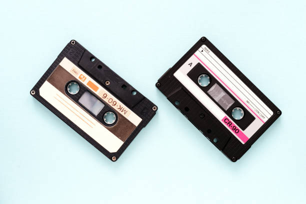istock Two vintage audio tapes on a light blue background close-up. Top view 1187381311