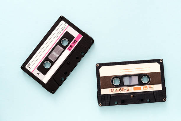 istock Two vintage audio tapes on a light blue background close-up. Top view 1187381321