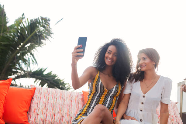 istock two latin friends take a selfie 1187389123