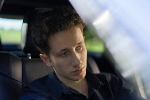istock Young attractive driver in a car driving in greenery 1187389847