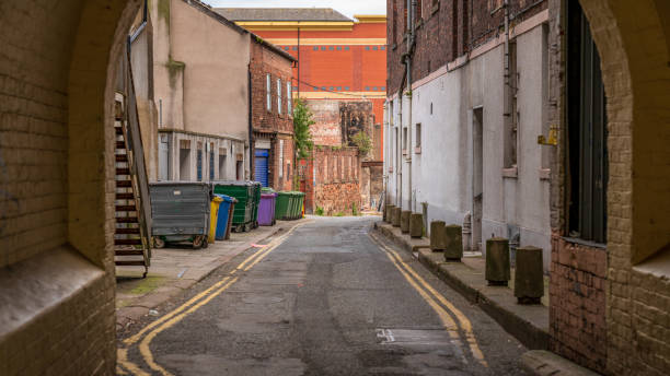 A small road with garbage containers on the side, seen in Carlisle, Cumbria, England, UK