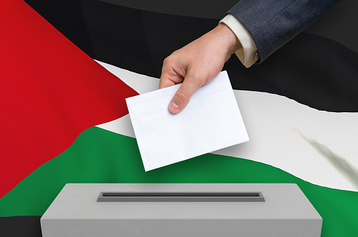 Election in Palestine - voting at the ballot box. The hand of man is putting his vote in the ballot box. 3D rendered illustration.
