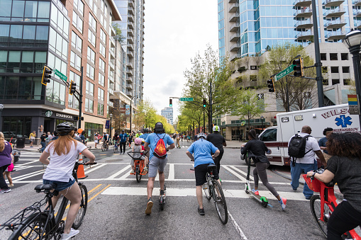 Atlanta, USA - April 7, 2019: Pedestrians ride and walk on the road during the event Streets Alive. The city designates specific major roadways for the public to enjoy the festivities.