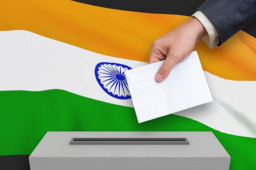 Election in India - voting at the ballot box. The hand of man is putting his vote in the ballot box. 3D rendered illustration.