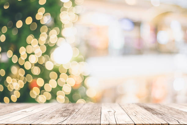 istock Wooden table with space with Christmas tree and blurred light bokeh for mock up or montage your product advertisement. 1187392743