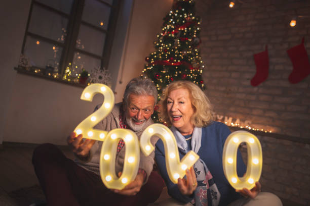 istock Senior couple holding illuminative numbers 2020 1187392914