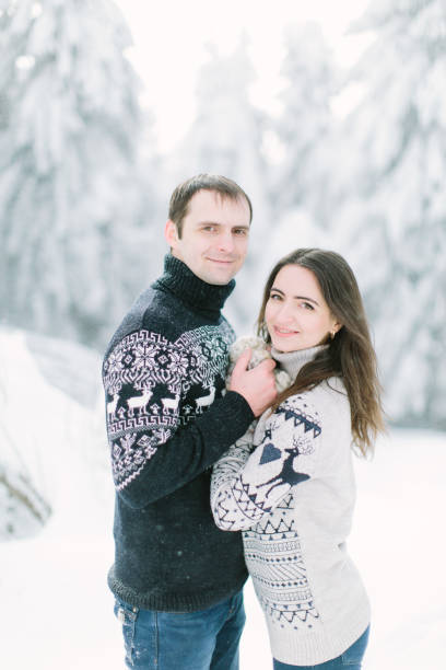 istock young couple having fun together in snowy forest 1187393295