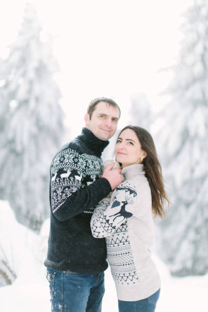 istock young couple having fun together in snowy forest 1187393454