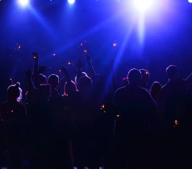 Photo of crowd of people at night open air festival