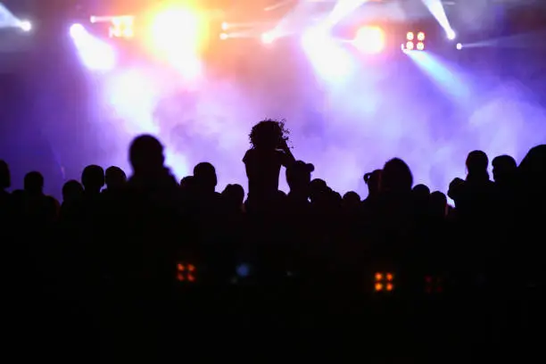 Photo of crowd of people at night open air festival