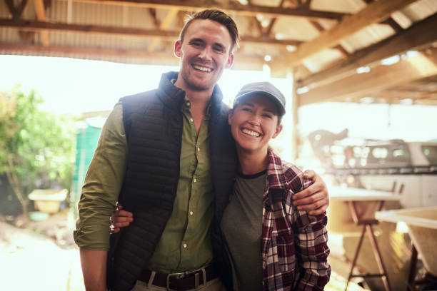 Farming is second nature to us Portrait of a happy young couple posing together at their farm the farmer and his wife pictures stock pictures, royalty-free photos & images