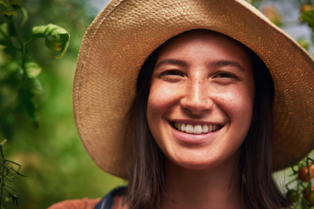 Portrait of an attractive young female farmer posing outdoors in the fields at her farm