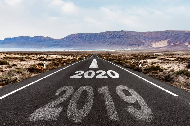 istock year 2020 with arrow pointing ahead on asphalt road 1187395168