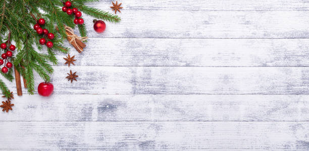 Christmas background with fir tree and red gifts on wooden table. Horizontal banner. Top view Copy space stock photo