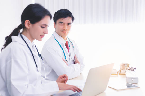 istock Smart doctor look confident, determined. Teacher look at camera and teaching young intern or medical student in hospital office at hospital or university. Professional doctor is specialist doctor. 1187396346